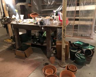 The basement is full with plant growing and potting equipment