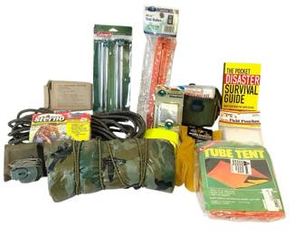 TEWA809 Vintage Camping And Emergency Equipment  Includes emergency tent, blanket, and survival guide; folding camp stove and fuel; spare tent stakes; hangsble tarp, fuel packets, and compass.
