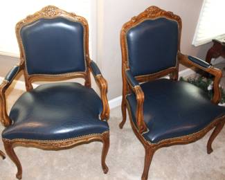 Four leather arm chairs.