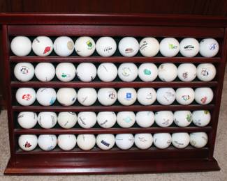 Fifty golf balls display case. With balls from a variety of courses played.