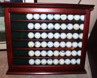 Seventy two golf ball display case with balls from a variety of courses played.