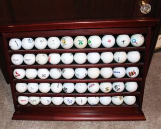 Fifty golf balls display case. With balls from a variety of courses played.