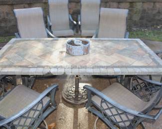 Patio table with eight swivel arm chairs w/umbrella stand.