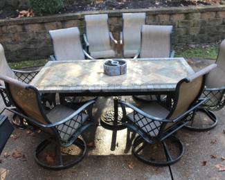 Patio table with eight swivel arm chairs w/umbrella stand.