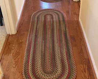 Multiple braided rugs throughout home - including a room size one