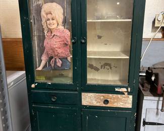 Vintage mostly green cabinet with Dolly Parton poster