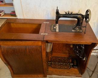 Opened cabinet for rare Secor Fairy Treadle Sewing machine