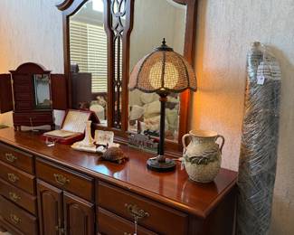 Large dresser with matching mirror, roll of material and decor