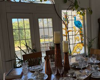 Plants, china and cooper candle holders on oak table with 6 chairs