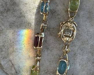 #113- $295 - multi colored stone bracelet on 10kt yellow gold . Size 7 1/4