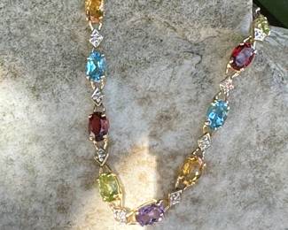 #113- $295 - multi colored stone bracelet on 10kt yellow gold . Size 7 1/4