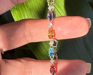 #113- $295 - multi colored stone bracelet on 10kt yellow gold . Size 7 1/4