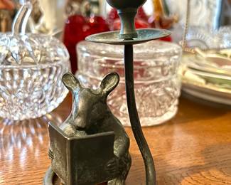 it’s bronze. It’s and it’s made by enesco and it’s just a cute little mouse.