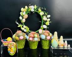 Whimsical Easter Decor: Vibrant Wreaths, Nestled Eggs, And Adorable Figurines For A Festive Spring Display.
