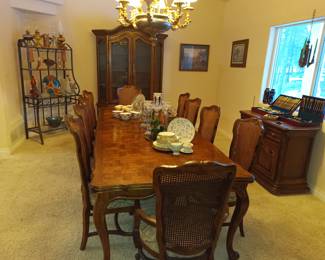 Dining table with 10 chairs, shown with leaves in for full extension