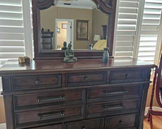 Solid wood dresser with attached mirror.