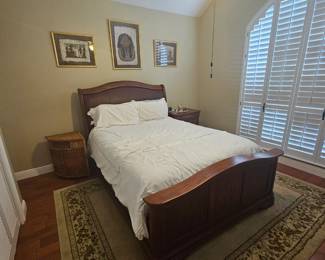 Solid wood queen size bed with headboard, footboard, and side boards.