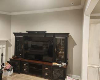 Bassett Custom Entertainment center holds up ton70" TV 

,65"  Sony Smart TV 