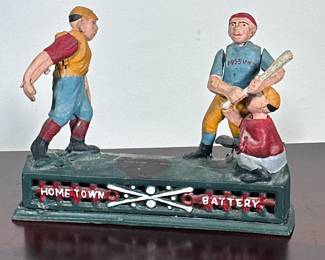 BASEBALL COIN BANK | Metal coin bank with moving baseball scene on top, place coin in pitchers hand and he will throw the coin into the bank. - h. 6.5 x w. 2.5 x l. 9 in
