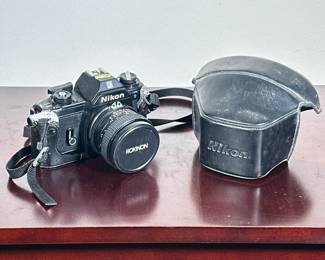 NIKON EM SLR CAMERA | Nikon EM SLR film camera with Rokinon Auto SC lens and leather case. - h. 4 x w. 4.5 x l. 6 in