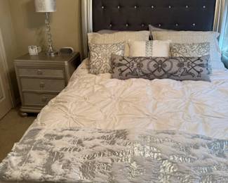 Ashley queen bed, padded headboard and a silver footboard two matching night stands and lamps