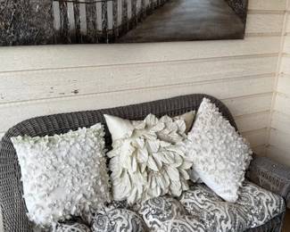 Love seat with pad and pillows and canvas painting