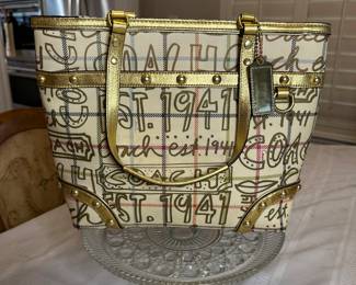 Coach Multi symbol 1941 handbag with gold leather trim and handles $70 like new