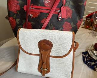 Coach black with red roses leather shoulder bag with red leather trim and handles $70 like new.
Dooney and Bourke white peppled leather handbag with brown leather trim and crossbody strap $65 like new except small ink mark in inside flap 