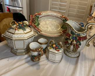 Fitz and Floyd Bountiful Christmas 8 piece buffet set. Tureen and covered dish are crème/gold trim  as well as bows. Topped with a display of fruit and pine leaves. The serving dish has red/gold bows with berries, 2 pine cones and green holly leaves. The pitcher has red/gold bow with 2 gold and crème bells, green holly leaves and berries and pine leaves. A spectacular set for $120
