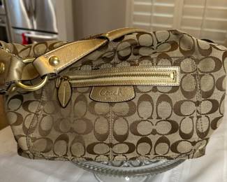 Coach Brown and tan canvas with gold leather trim with gold leather trim and tan leather handles $55 like new