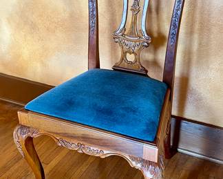 Set of 8 heavily carved Chippendale dining chairs.