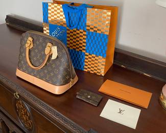 Louis Vuitton handbag with original receipts and Lego cross promotion bag.