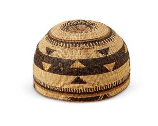 5
A Hupa/Yurok/Karuk polychrome basketry hat
Early 20th century; Northern California
The twined hat with imbricated dark and light brown banded stripe and geometric motifs
3.625" H x 6" Dia.
Estimate: $400 - $600