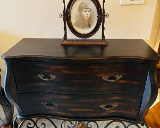 She must be important to have such an impressive piece of furniture under her.