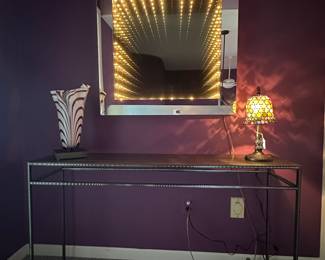Mesmerizing Infinity Light Mirror Shown with a Chrome Side Table.