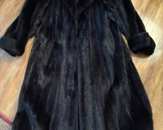 Luxurious black mink with graceful sweep in a size 16.