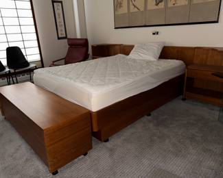 King-size bed with matching night tables and large teak blanket chest.
