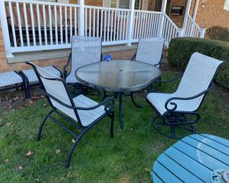 Glass top metal framed patio table with 2 chairs, 2 swivel chairs and 2 footrests 