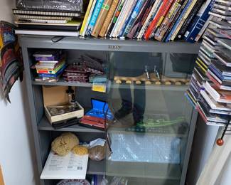 Metal cabinet with shelves and sliding glass doors