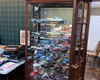 Large enclosed display cabinet with glass shelves and  mirrored back 