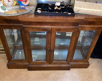 Wood display cabinet with glass front and mirrored back 