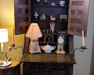 70s Spanish style secretary with flip down desk and storage below and attached side candle holders 