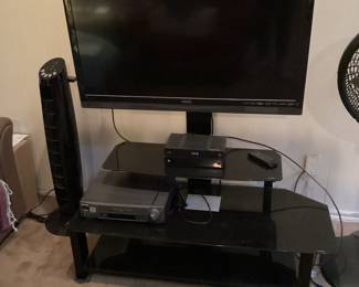 Television and stand with media center