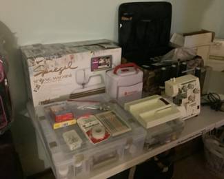 Three sewing machines and many accessories.