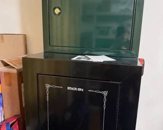 Small pistol safe (green) and gun safe by stack on