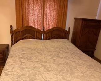 King size bed with mattresses and frame that matches other bedroom furniture pieces