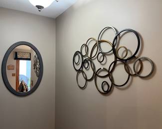 Oval mirror, metal circles artwork