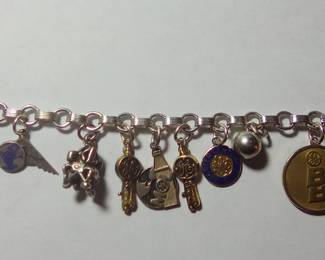 STERLING charm bracelet. Not all charms are sterling. From the left to the right. #2 Charm is a sterling satellite charm. #4 charm is a lunar lander (from when we landed on the Moon). #5 is a Rocket 20 years working for GE. #6 is GE MOL charm with a rocket and the earth. #7 is 10 kt gold rocket 25 years working for GE. #8 is 10kt gold 1/4 century working for GE.
