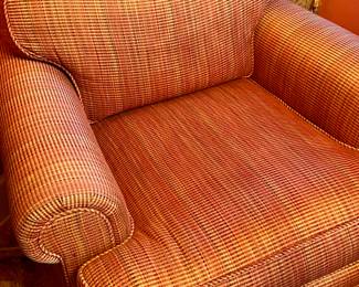 A newly redone pair of large club chairs in gold, green and red woven silk/cotton.