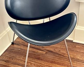 An original black leather clam shell chair…not a reproduction 